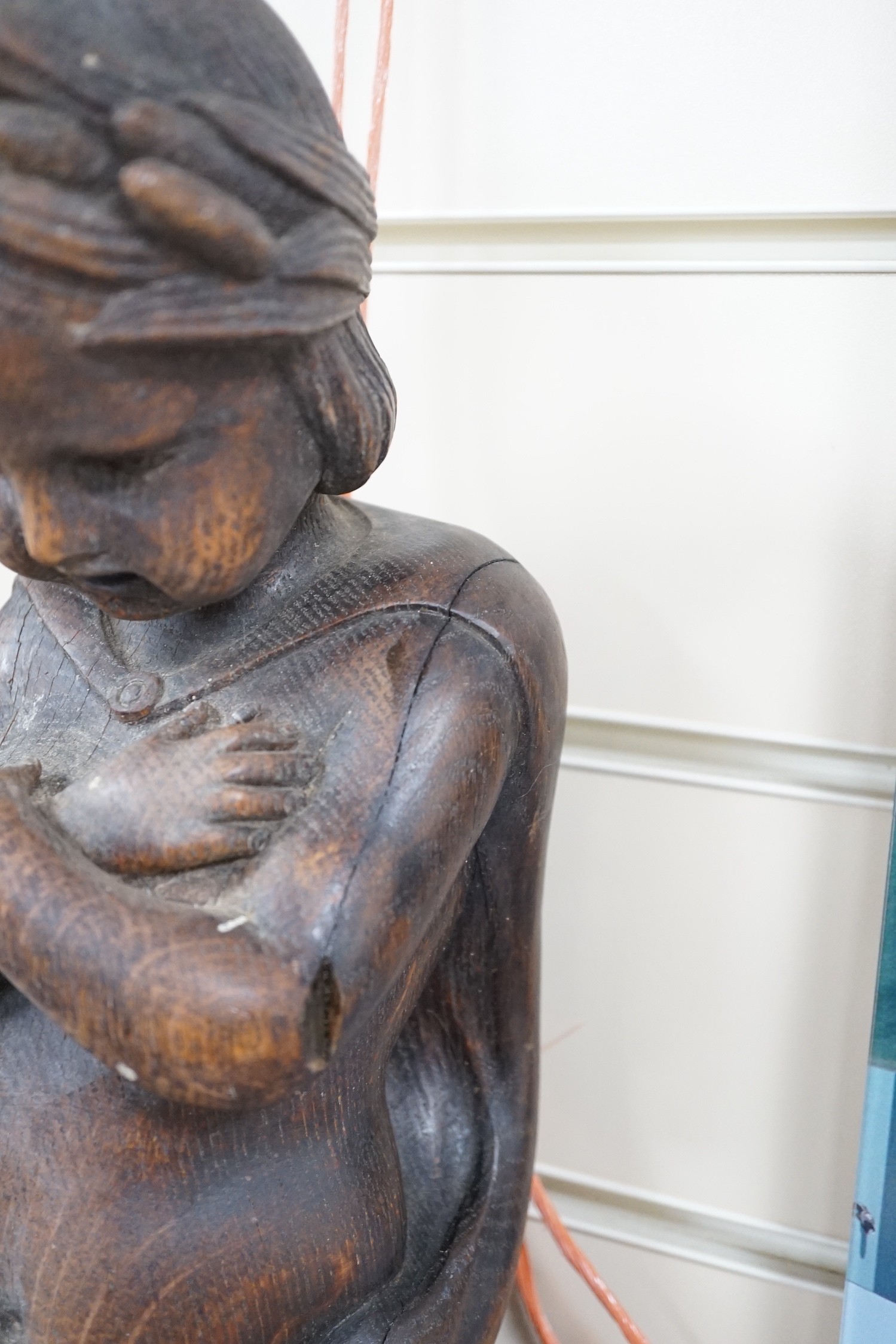 A carved figural wall mount. 64cm tall